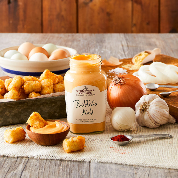 photo of tater tots being dipped in a bowl of Stonewall Kitchen Buffalo Aioli
