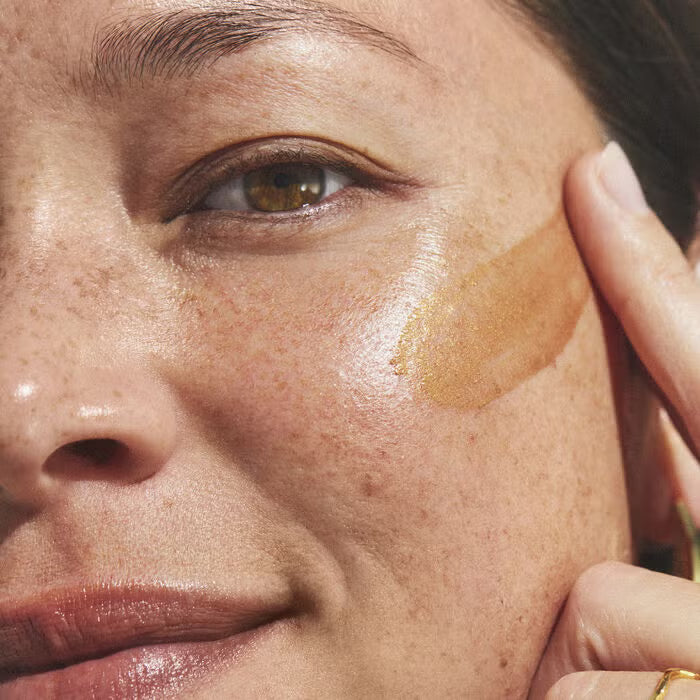 woman applying bronzing serum
