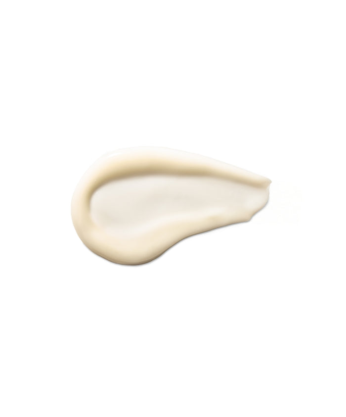 Creamy texture of Coconut Clean Cleansing Balm spread on a white background, highlighting its smooth and nourishing clean beauty formula.